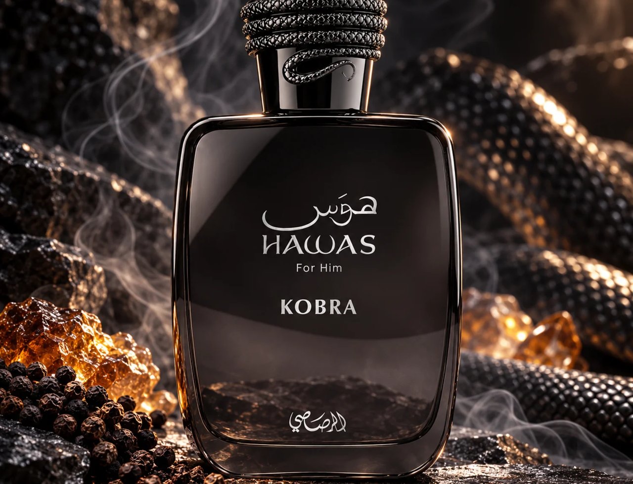 RASASI Hawas Kobra by Rasasi 100ml EDP — Black glass bottle with textured snake-like cap, set on dark rocks with amber crystals and peppercorns, wisps of smoke rising.