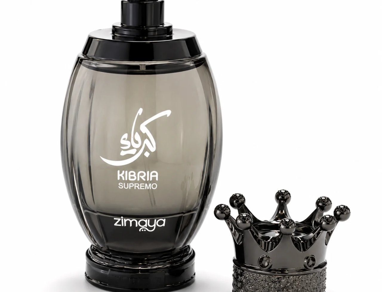 Zimaya Kibria Supremo — A smoky grey oval perfume bottle with white Arabic script and text 'KIBRIA SUPREMO ZIMAYA' sits next to a black crown-shaped cap on a white background.