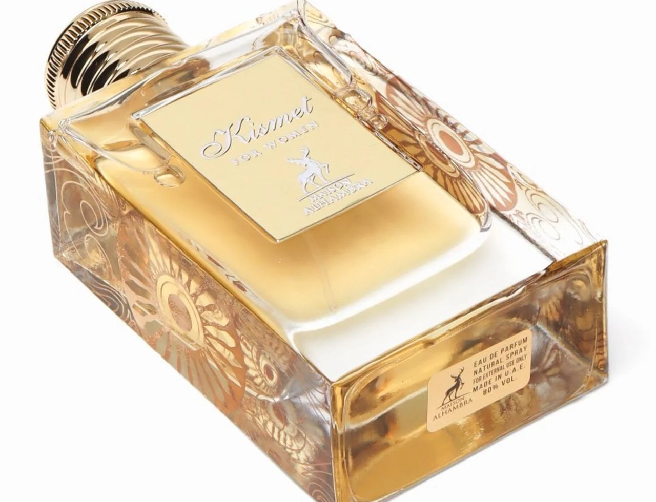 Maison Alhambra Kismet for Women 100ml — Botol kaca jernih dengan penutup emas bertekstur, dihiasi corak bunga keemasan yang rumit. Cecair berwarna keemasan di dalam.