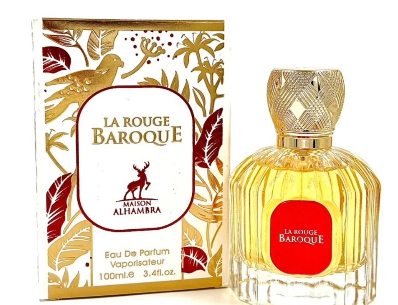 Maison Alhambra La Rouge Baroque 100ml — A perfume bottle and its box are displayed against a white background. The box features a gold and red floral and bird design. The bottle is clear glass with fluted sides, containing yellow perfume, and has a gold patterned cap. | Maison Alhambra La Rouge Baroque 100ml — Botol