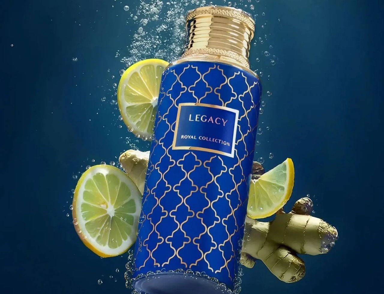 Legacy by Maison Asrar 100ml EDP Unisex — Blue bottle with gold pattern submerged in water with lemon slices and ginger root
