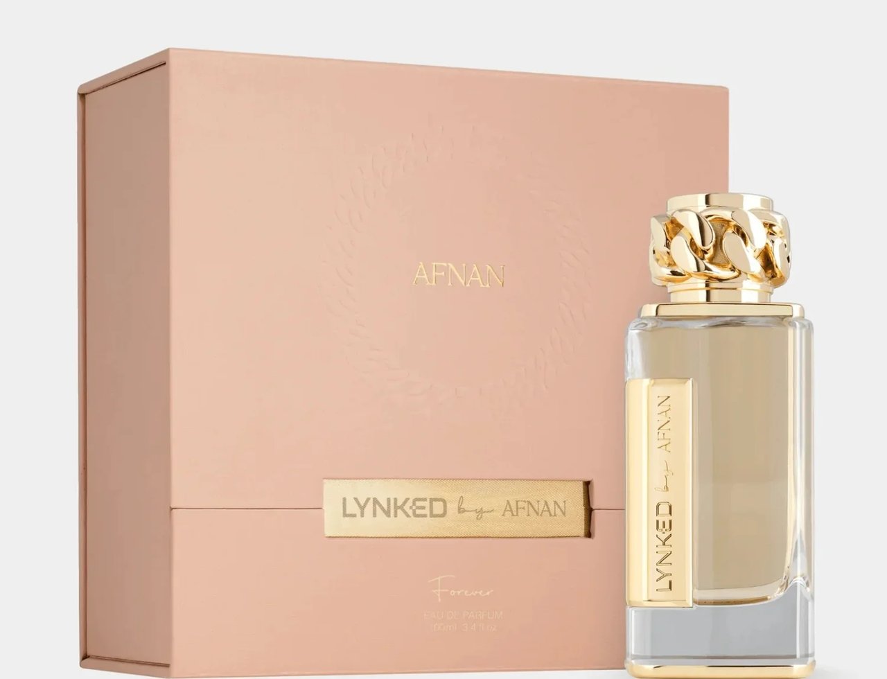 Afnan Lynked Forever by Afnan 100ml Eau De Parfum — A gold-capped perfume bottle stands next to its rose gold presentation box, both featuring embossed branding.