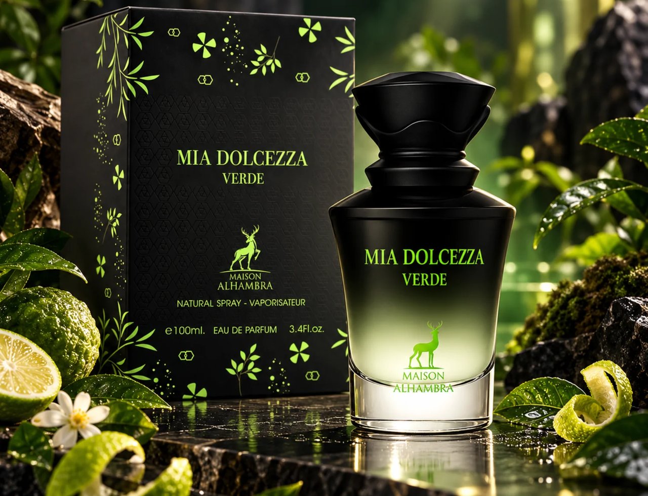 Maison Alhambra Mia Dolcezza Verde — Perfume bottle and box with bergamot, lime zest, and green foliage on a dark reflective surface.