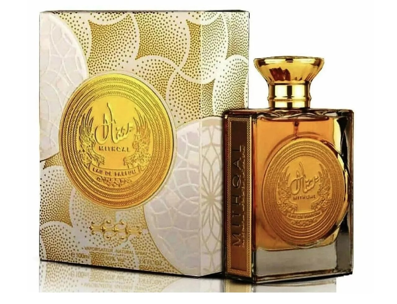 Ard Al Zaafaran Mithqal 100ml — Botol minyak wangi kaca keemasan dengan penutup emas, diletakkan di sebelah kotak hadiah bertekstur emas dan putih.