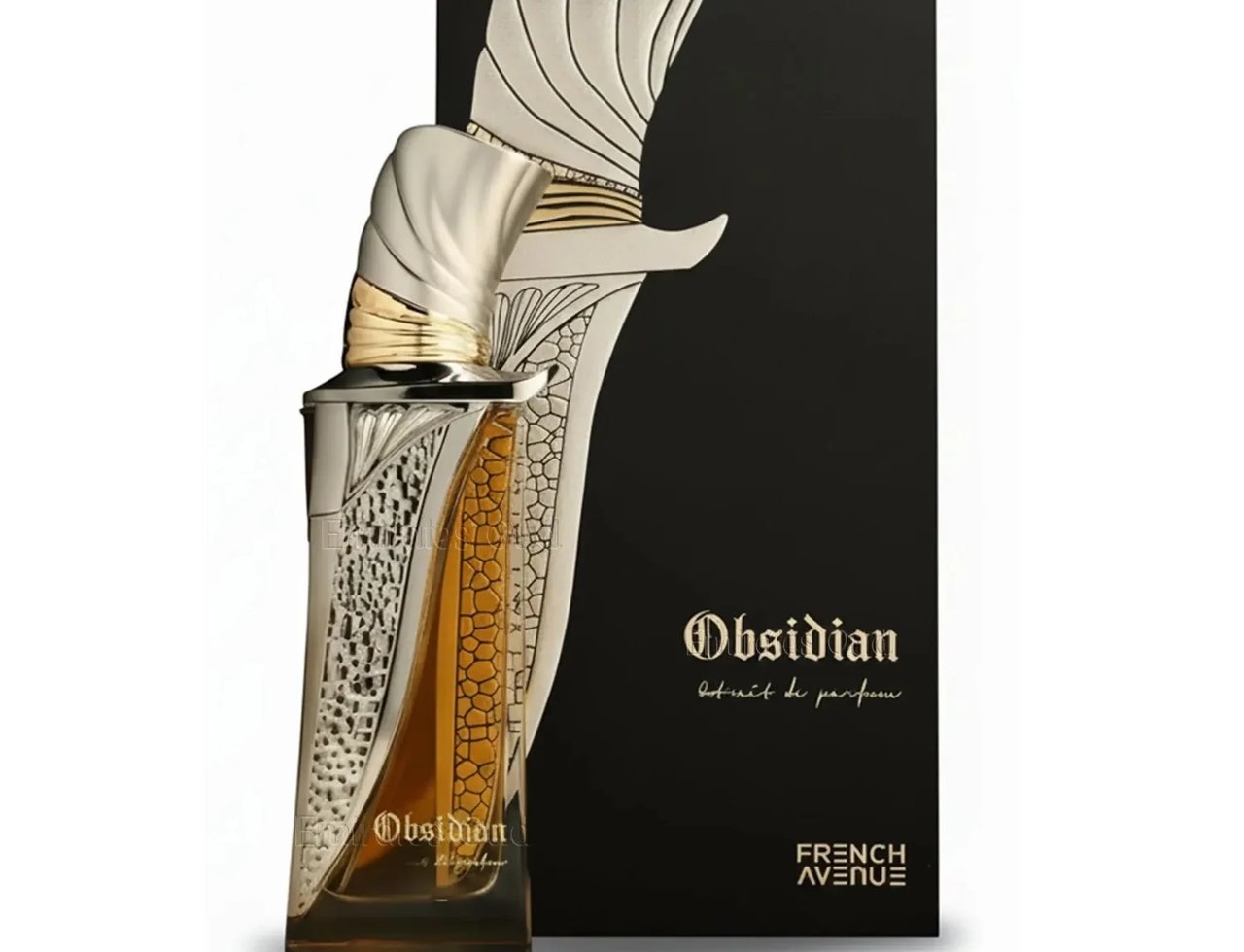 French Avenue Obsidian Eau De Parfum — A tall, ornate perfume bottle with silver and gold accents, featuring a textured pattern and amber liquid, stands beside its matching black and silver box with embossed detailing.