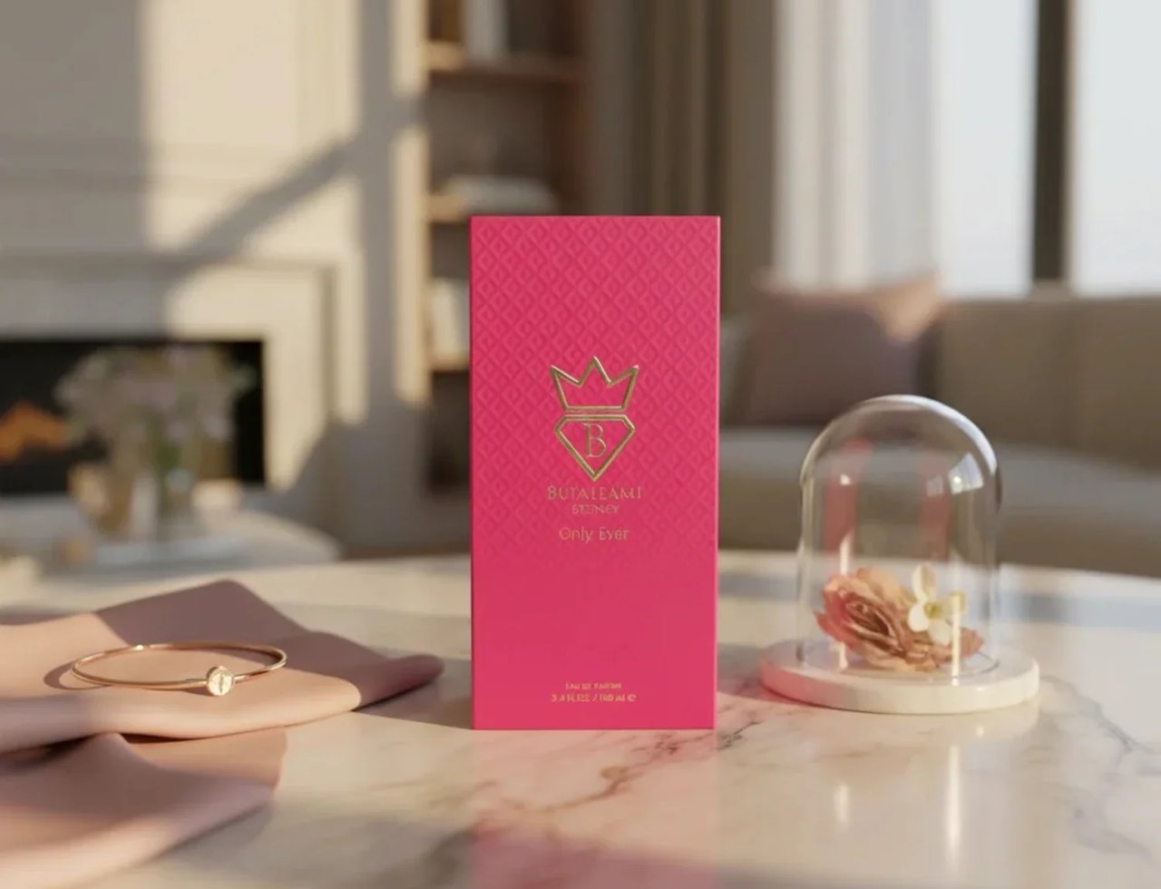 Bujairami Only Ever by Bujairami 100ml EDP — Pink textured box with gold crown logo, displayed on a marble surface with a delicate bracelet and a glass dome containing a dried rose.