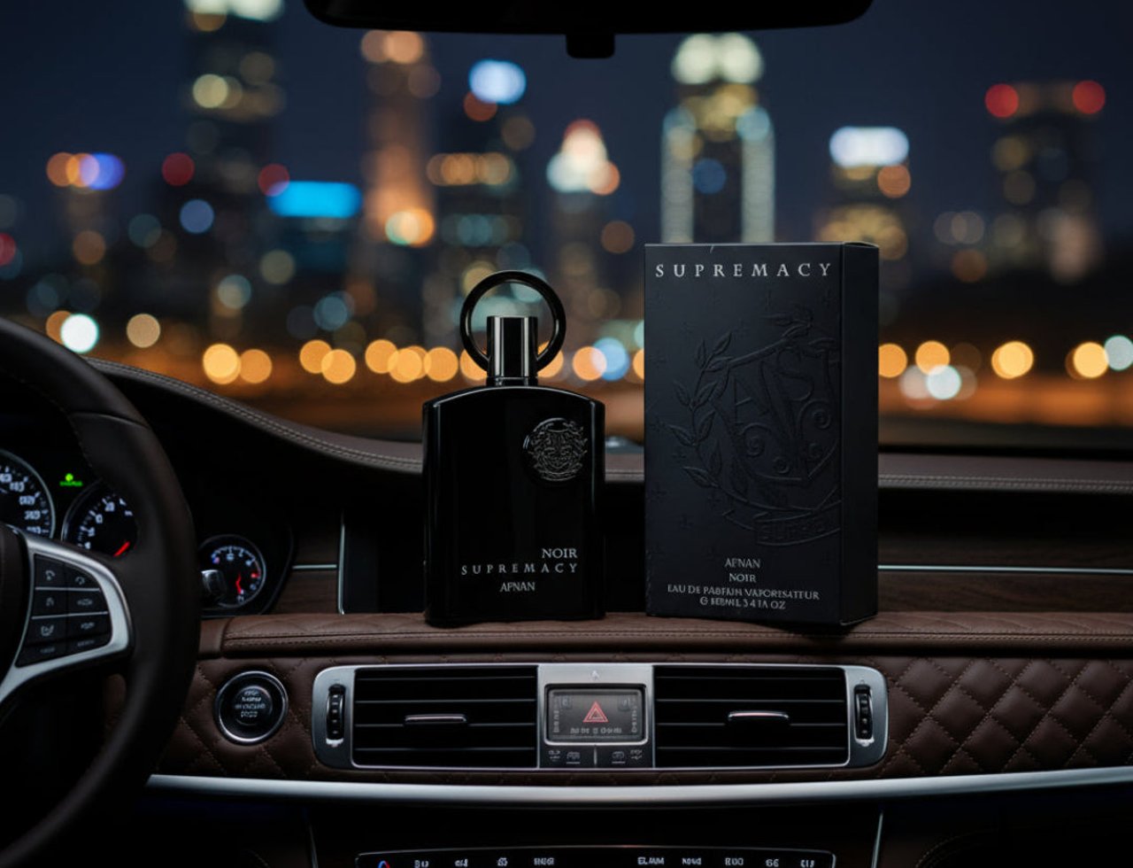 Afnan Supremacy Noir by Afnan 100ml EDP Men — Black perfume bottle and box on a car dashboard at night with city lights