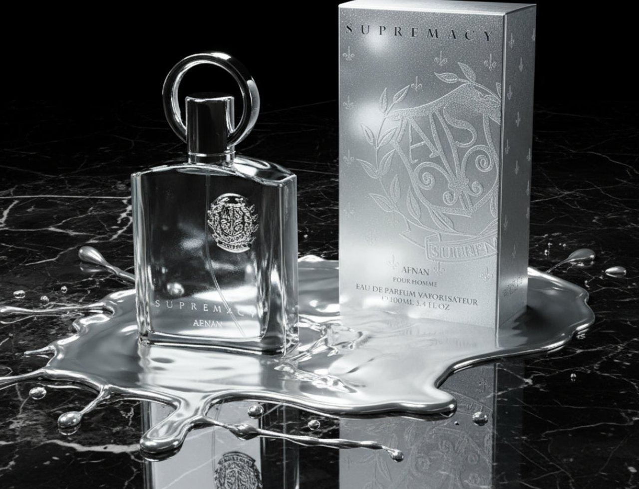 Afnan Supremacy Silver by Afnan — Clear glass bottle and silver box on a black marble surface with liquid silver splashes.