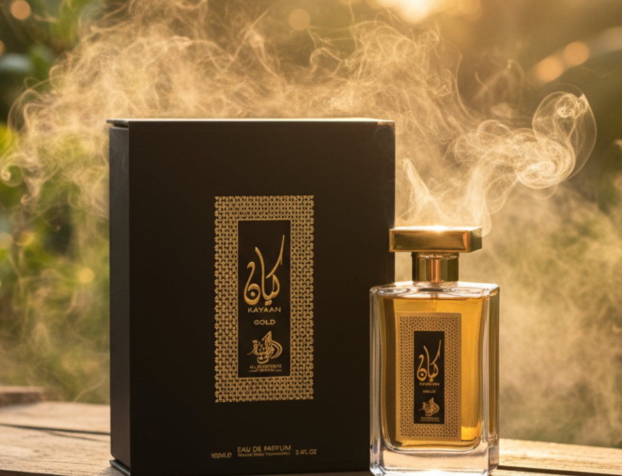 Al Wataniah Kayaan Gold — Black box and gold bottle with smoke effects in sunlight