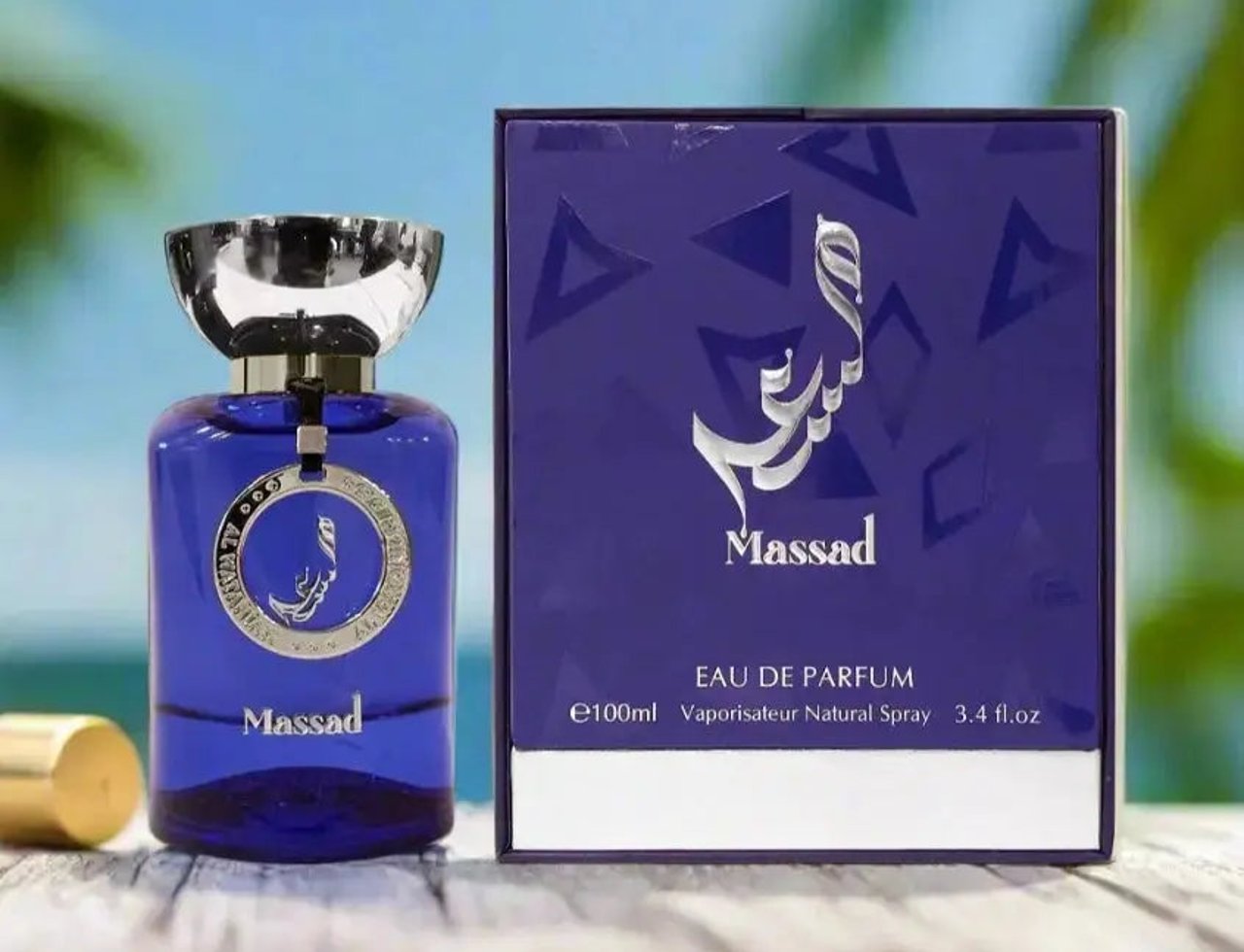 Al Wataniah Massad by Al Wataniah For Him 100ml Extract — Blue glass bottle with silver cap and tag, next to a purple box