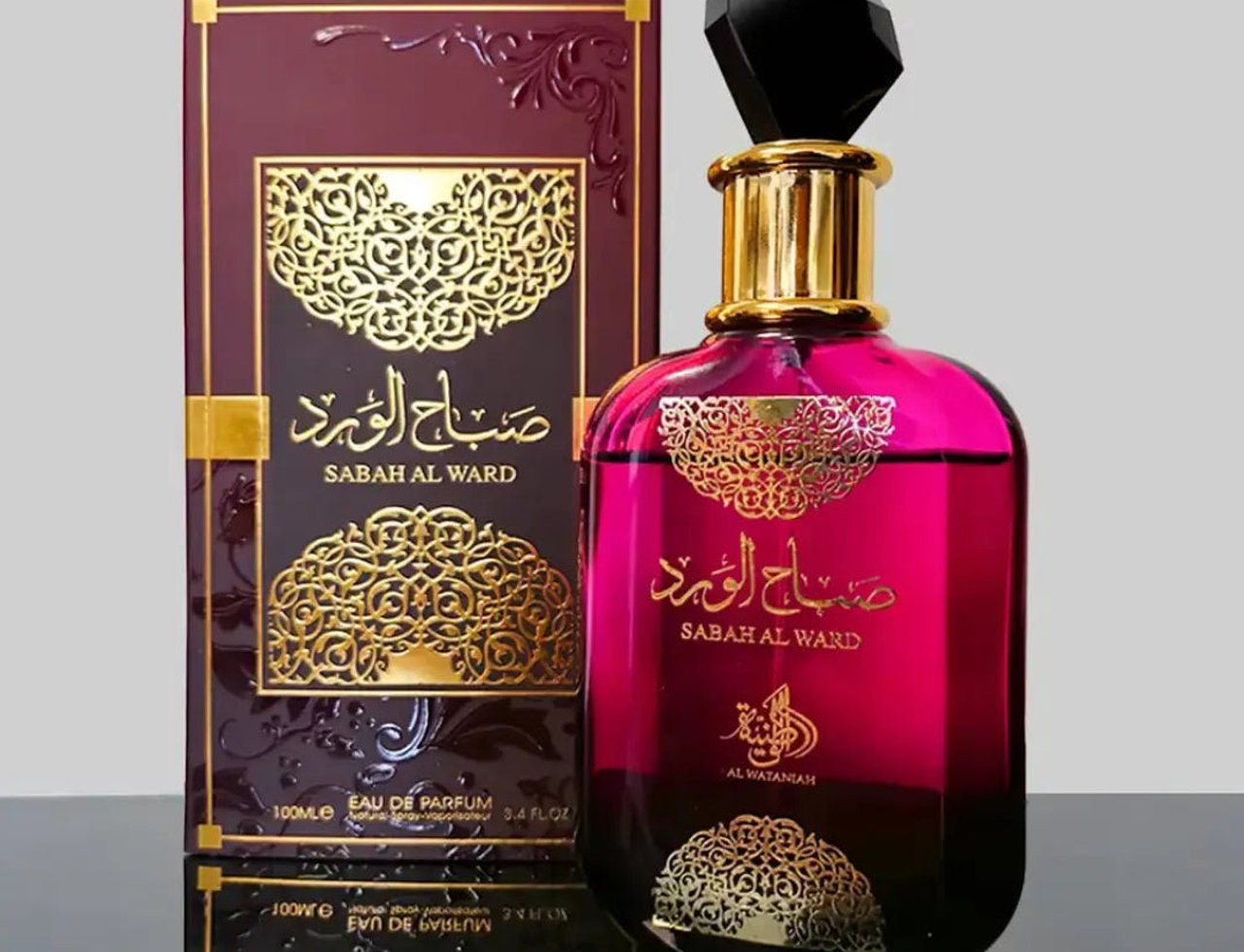 Al Wataniah Sabah Al Ward — Pink gradient glass bottle with gold ornate label and black faceted cap, next to matching box.