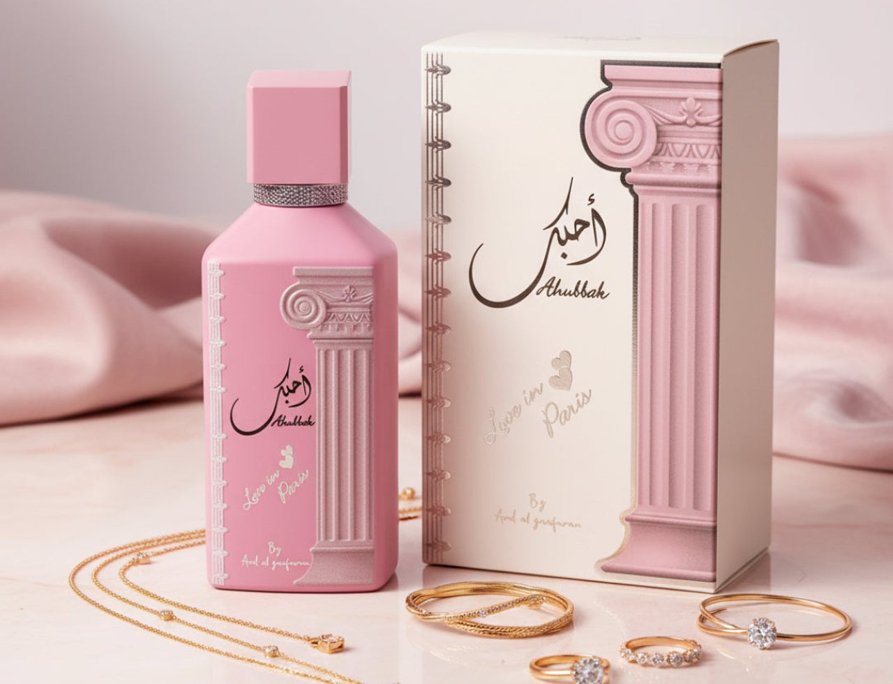 Ard Al Zaafaran Ahubbak Love In Paris EDP 100ml Zaafaran — Pink bottle and box with gold jewelry and pink silk fabric