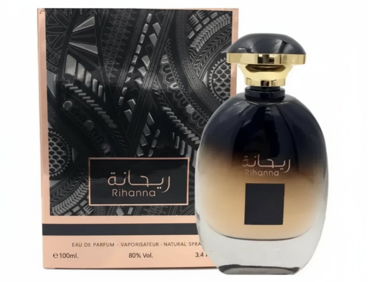 Ard Al Zaafaran Rihanna — Botol minyak wangi gelap dengan penutup emas, diletakkan di sebelah kotak yang mempunyai corak geometri hitam dan emas.