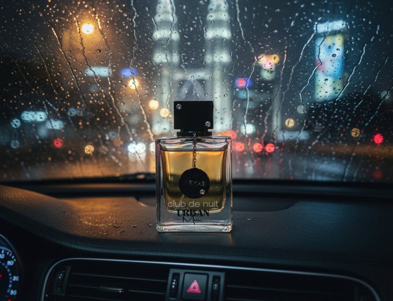 Armaf Club De Nuit Urban Man — Perfume bottle on a car dashboard at night with rain on the windshield and city lights
