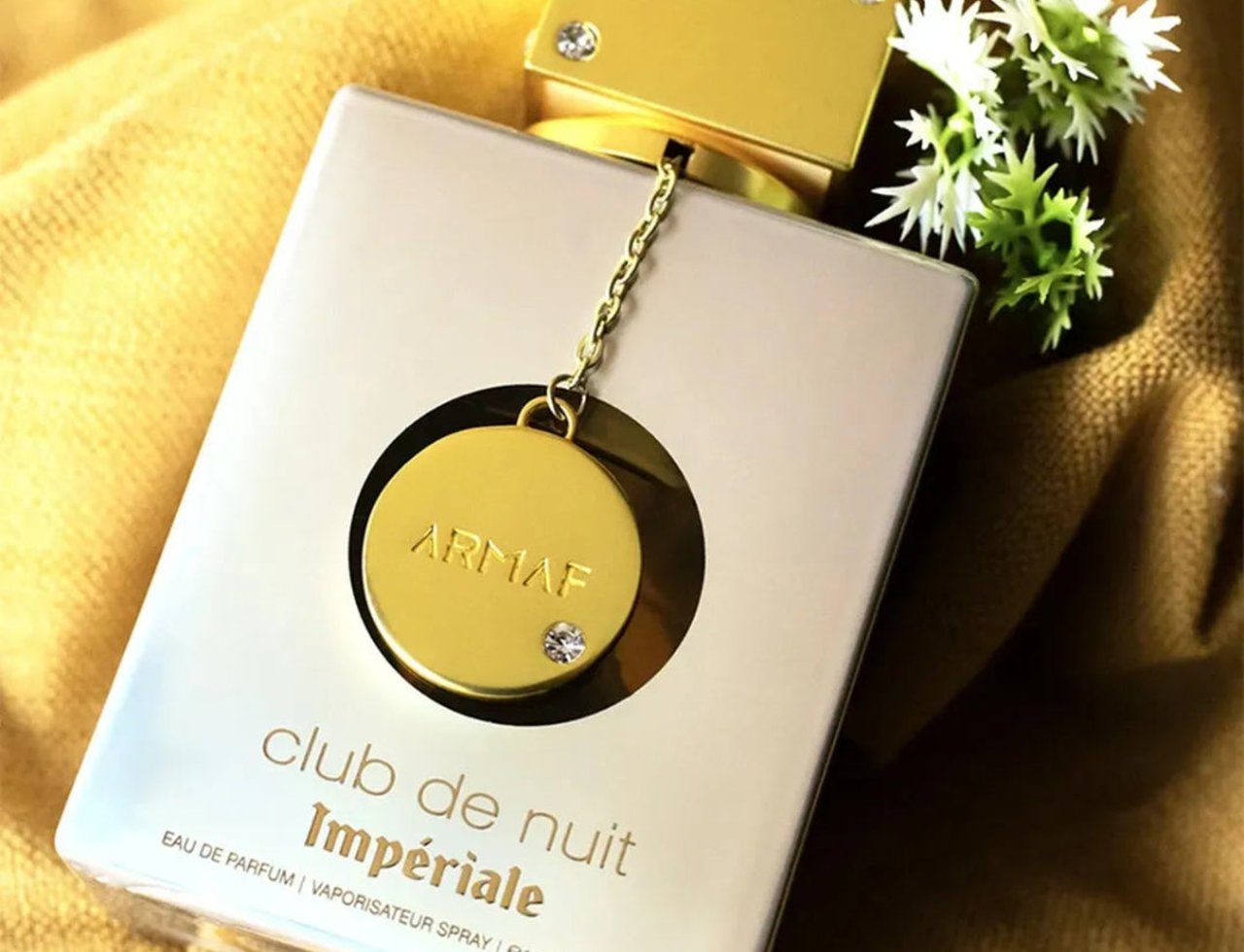 Armaf Imperiale Eau De Parfum Armaf 105ml — Gold cap with chain and charm on a beige bottle, with white flowers and gold