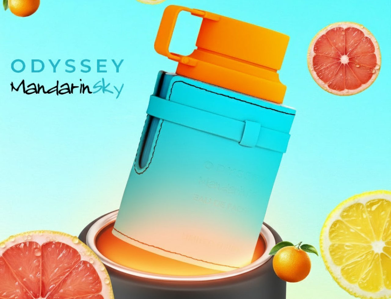 Armaf Odyssey Mandarin Sky — Teal bottle with orange cap surrounded by citrus fruits and a dark container.
