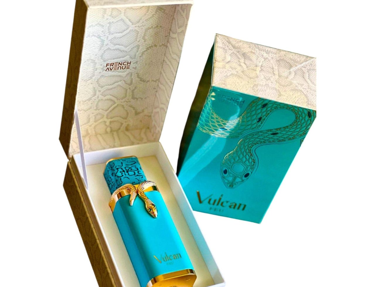 French Avenue Vulcan Feu by French Avenue 100 ml EDP — Turquoise perfume bottle with gold snake detail, presented in an open decorative box with a snake print interior, next to its matching box.