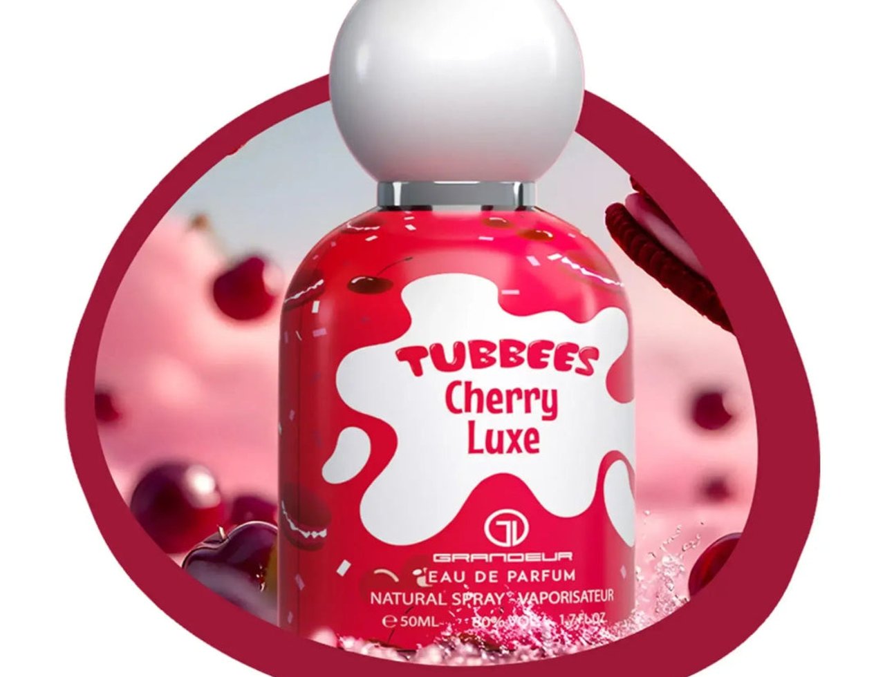 Grandeur Cherry Luxe by Grandeur Tubbees For Her 50ml — Botol minyak wangi merah dengan rekaan percikan putih, menampilkan buah ceri dan biskut dalam bingkai bulat.