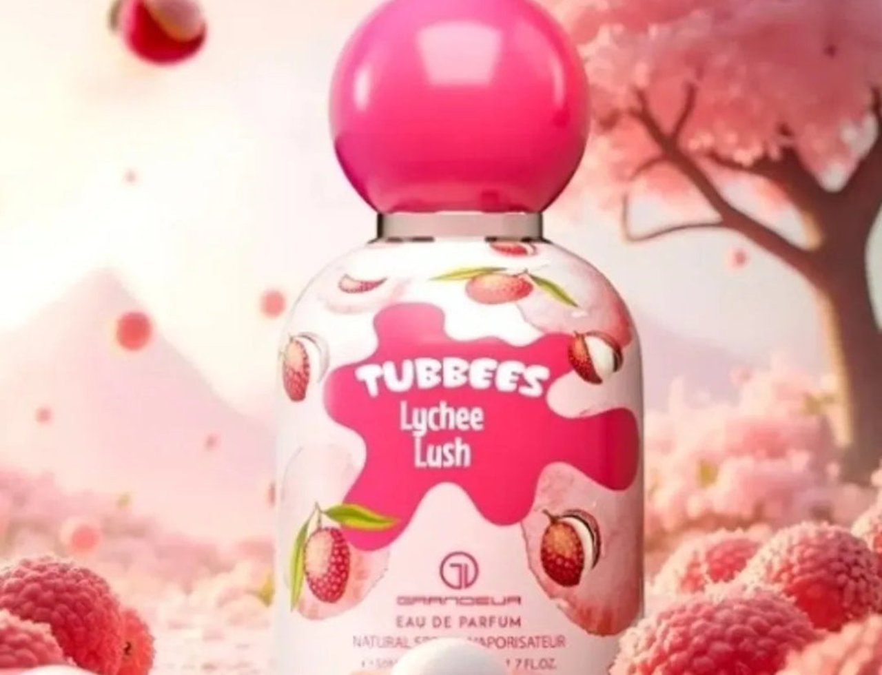 Grandeur Cherry Luxe by Grandeur Tubbees For Her 50ml — A pink-capped perfume bottle with lychee illustrations, surrounded by fresh lychees and cherry blossoms.