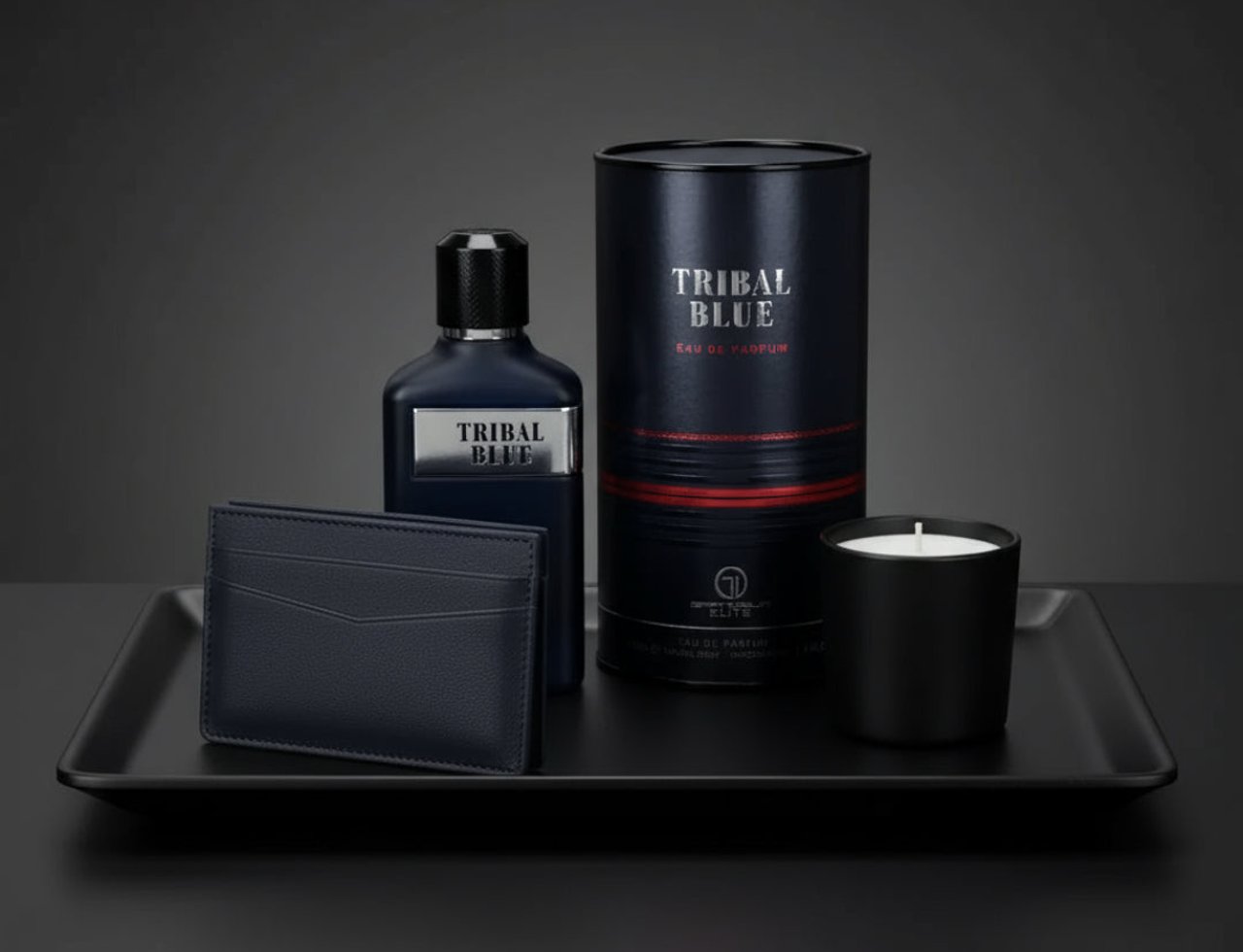 Grandeur Tribal Blue Man 100ml EDP Men — Dark blue perfume bottle, matching cylindrical box, black cardholder, and black candle on a black tray against a dark grey background.