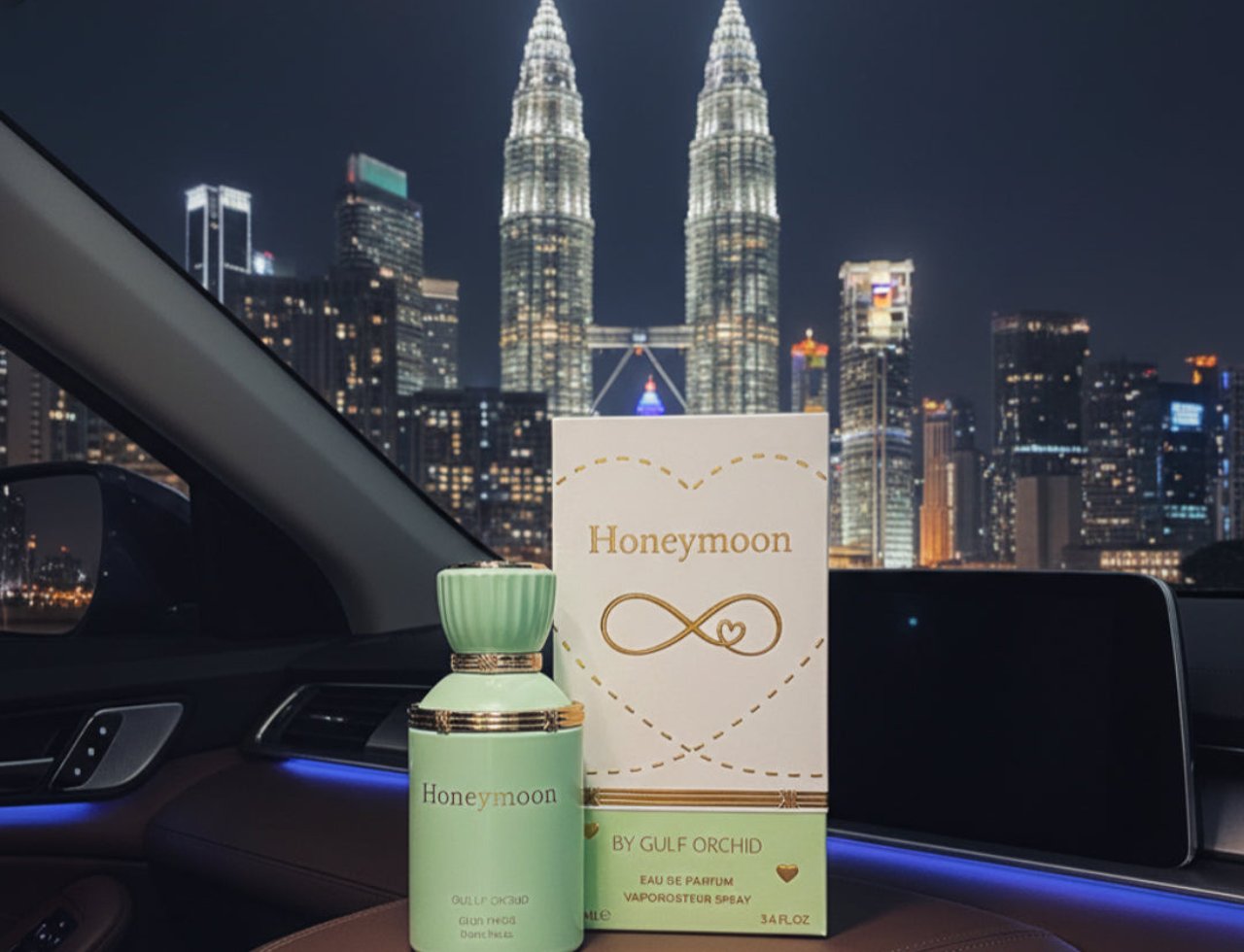 Gulf Orchid Honeymoon by Gulf Orchid Unisex 100ml — Green perfume bottle and box with gold accents, displayed inside a car at night with the Petronas Twin Towers visible in the background.