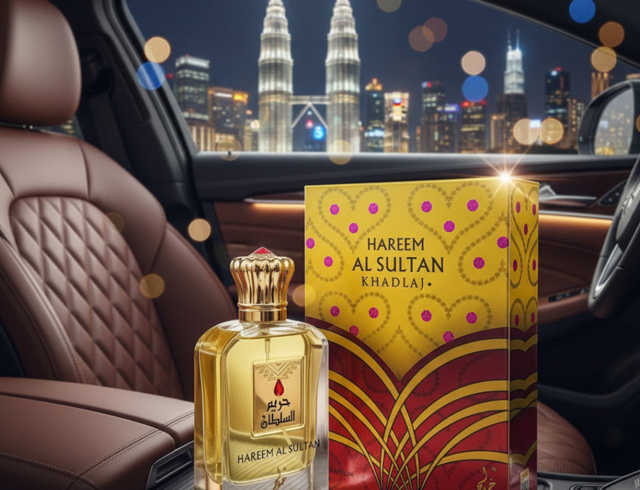 Khadlaj Hareem Al Sultan Gold 75ml — Perfume bottle and box displayed inside a car at night with city skyline and twin towers in the background.