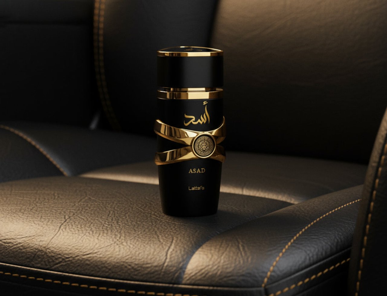 Lattafa Asad by Lattafa EDP 100 ml Men — Black tote bag with newspaper and gold-accented bottle on a subway platform