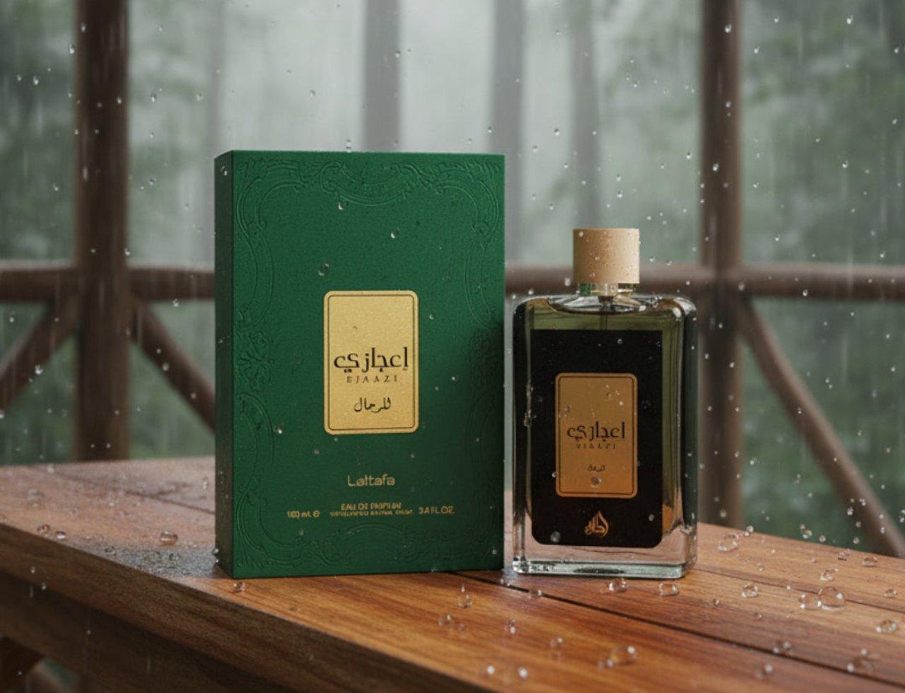 Lattafa Ejaazi — Green box and glass bottle of fragrance on a wooden table with rain falling outdoors