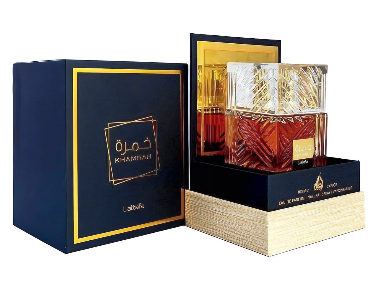 Lattafa Khamrah by Lattafa 100ml EDP Unisex — A dark blue box with gold trim and Arabic calligraphy sits beside a display of the Khamrah perfume bottle, featuring a faceted glass cap and amber liquid, presented on a wooden base.