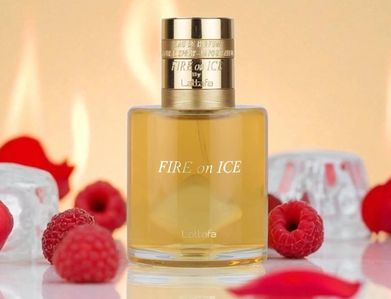 Lattafa Fire On Ice by Lattafa — Clear glass perfume bottle with gold cap, surrounded by raspberries and ice cubes against a