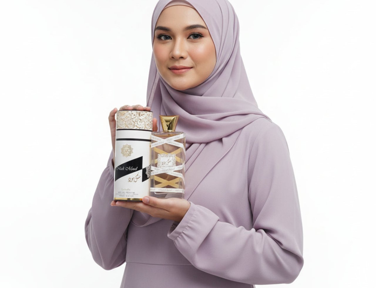 Lattafa Musk Mood by Lattafa 100ml EDP Unisex — Woman in a lilac hijab and dress holding a perfume bottle and its cylindrical box, both featuring gold accents and intricate patterns.