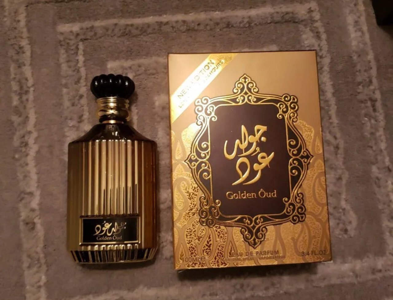Lattafa Golden Oud — Gold fluted perfume bottle and matching box with Arabic script and ornate gold frame on a grey textured