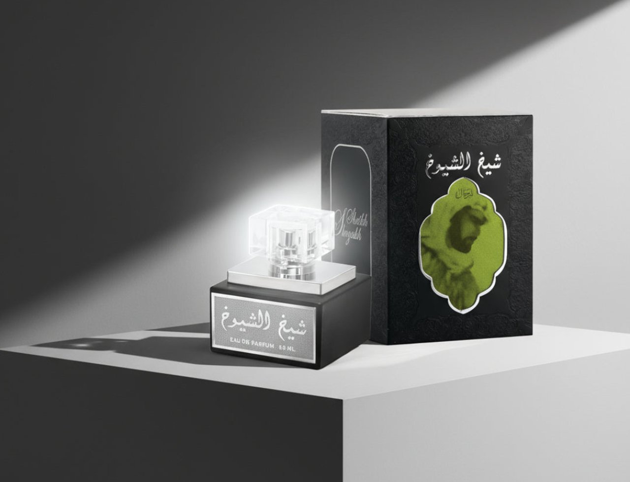 Lattafa Sheikh Al Shuyukh by Lattafa 50ml EDP Men — Black perfume bottle with a clear cap and silver base, next to its black textured box with a green circular design featuring a man's profile.