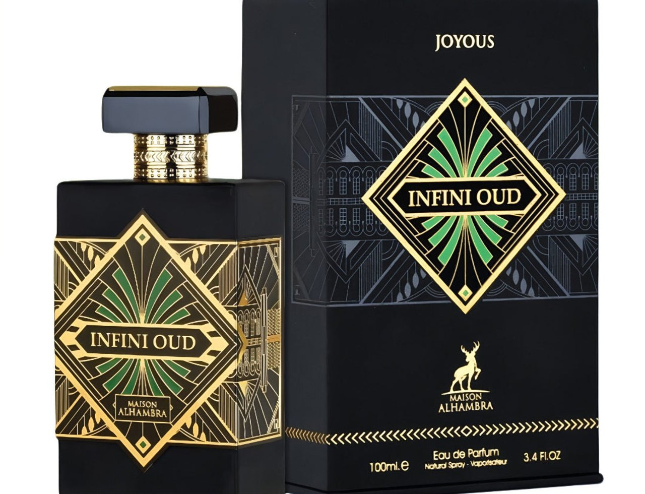 Maison Alhambra Infini Oud Joyous – Botol minyak wangi hitam dengan reka bentuk geometri emas dan aksen hijau, bersama kotaknya yang bercorak hitam dan emas.