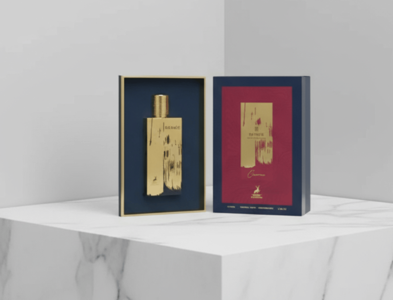 Maison Alhambra Renee Carmine EDP 100 ml — Botol dan kotak emas dipamerkan di atas permukaan marmar dengan latar belakang kelabu.
