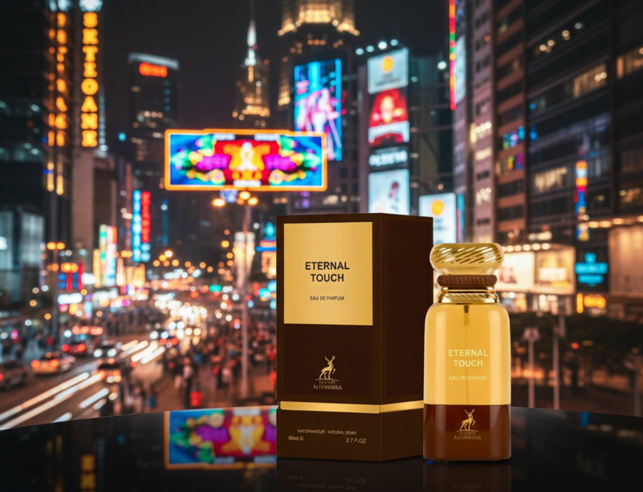 Maison Alhambra Eternal Touch by Maison Alhambra 80ml EDP — Botol dan kotak minyak wangi dipamerkan di permukaan reflektif dengan latar belakang malam bandar yang terang dan kabur.