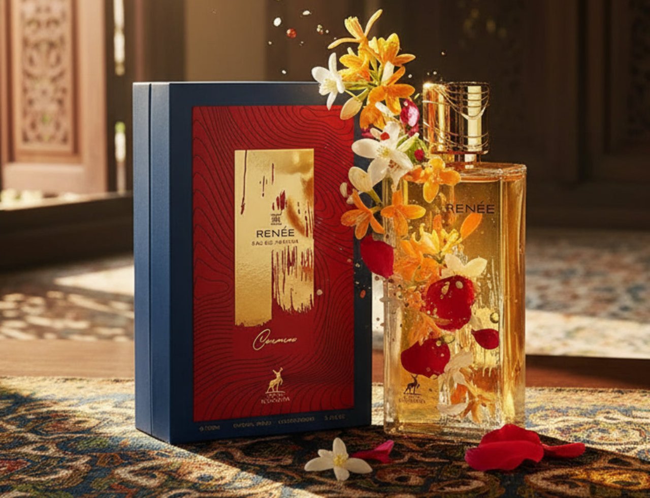 Maison Alhambra Renee Carmine EDP 100 ml Maison Alhambra — Perfume bottle and box adorned with vibrant orange and red flowers, petals scattered on a patterned cloth.