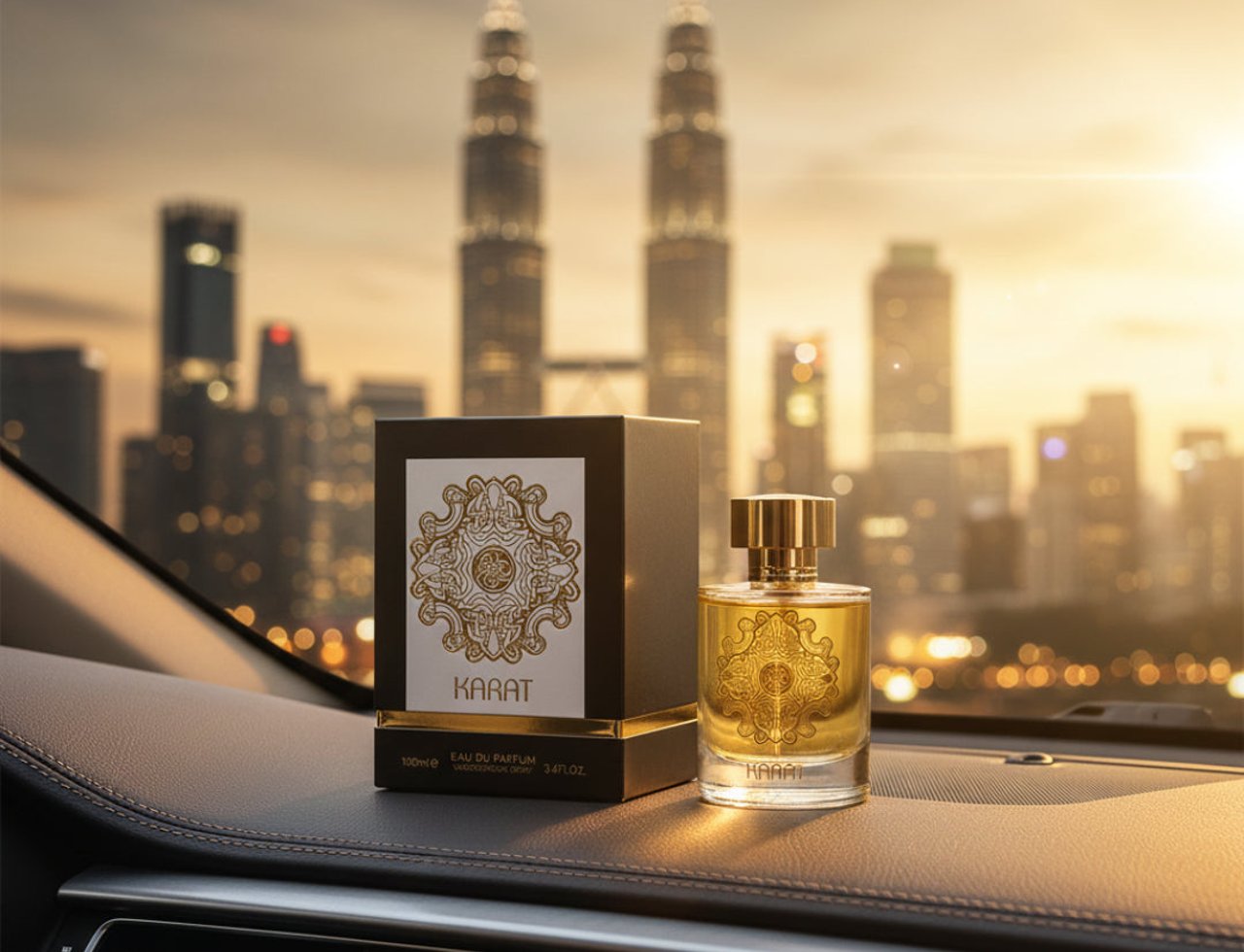 Maison Alhambra Karat by Maison Alhambra 100ml EDP — Perfume bottle and box on a car dashboard with Kuala Lumpur skyline at sunset in the background.