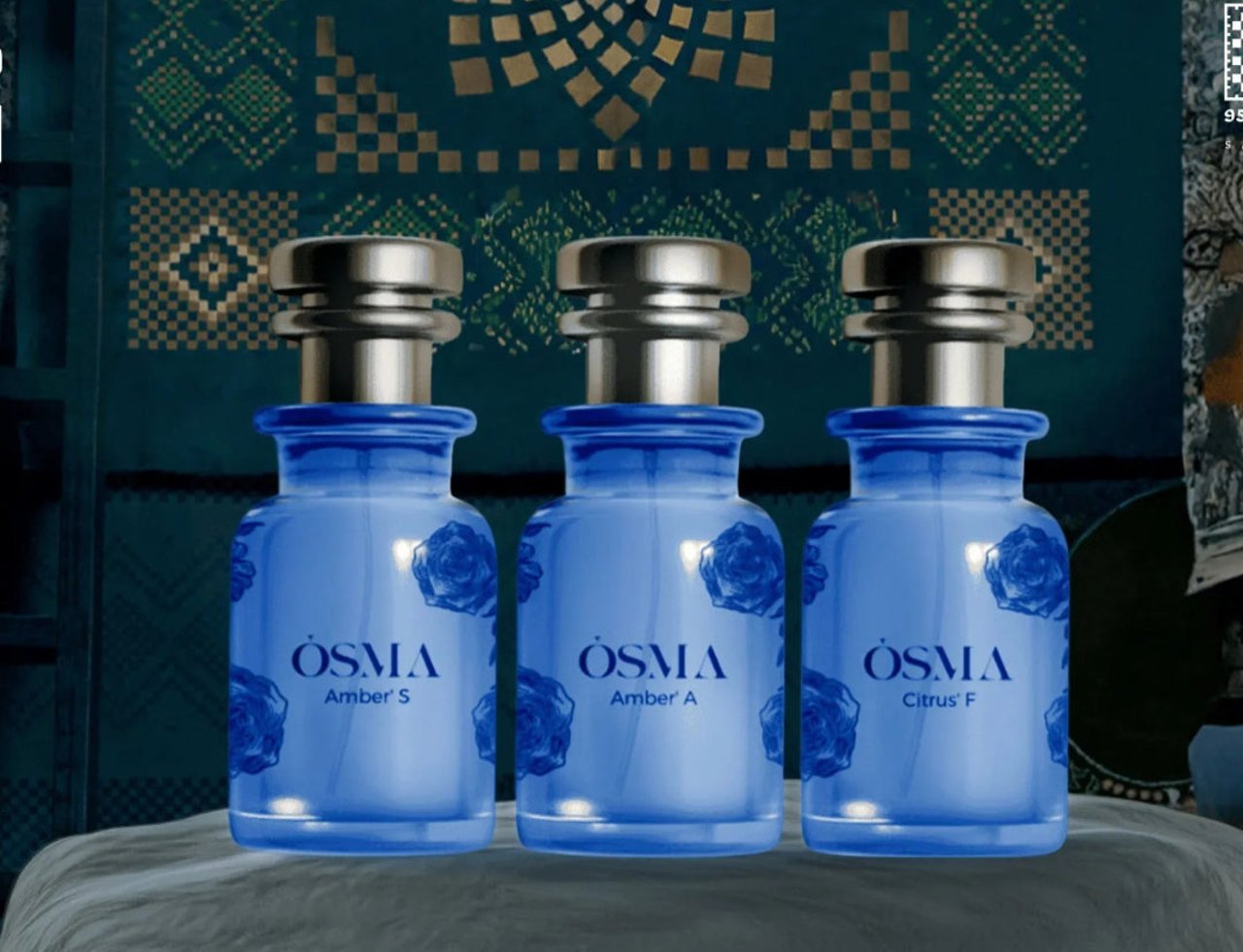 Osma Amber A Amber & Leather 75ml EDP — Three blue glass perfume bottles with silver caps, each featuring a rose design and the brand name 'OSMA' with scent names 'Amber S', 'Amber A', and 'Citrus F' below.