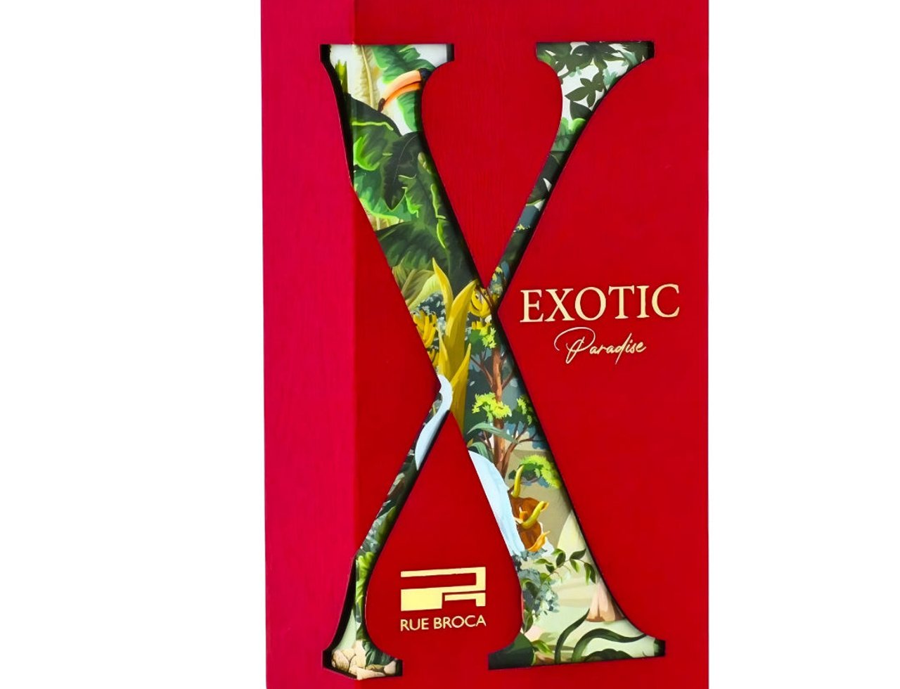 Rue Broca Exotic Paradise by Rue Broca 100ml EDP Women — Kotak hadiah merah dengan potongan besar 'X' mendedahkan cetakan hutan tropika di dalamnya, memaparkan teks 'EXOTIC Paradise' dan logo Rue Broca.