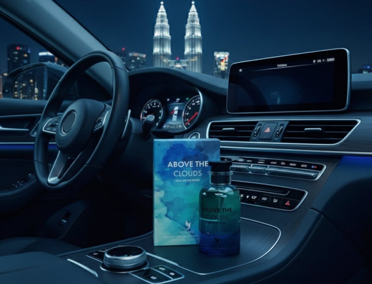 Volare Above the Clouds by Volare 100 ml Men — A perfume bottle and its box sit on the center console of a car at night, with city skyscrapers and twin towers in the background. | Volare Above the Clouds by Volare 100 ml Men — Botol minyak wangi dan kotaknya terletak di konsol tengah kereta pada waktu malam, dengan