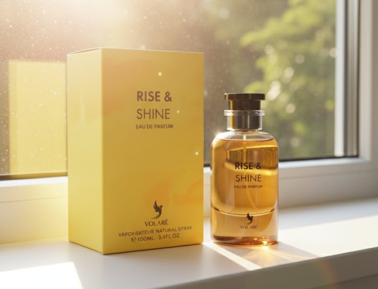 Volare Rise & Shine by Volare – 100 ml Unisex, featuring a yellow perfume box and a clear glass bottle with golden liquid, placed on a white surface with sunlight streaming from the left.