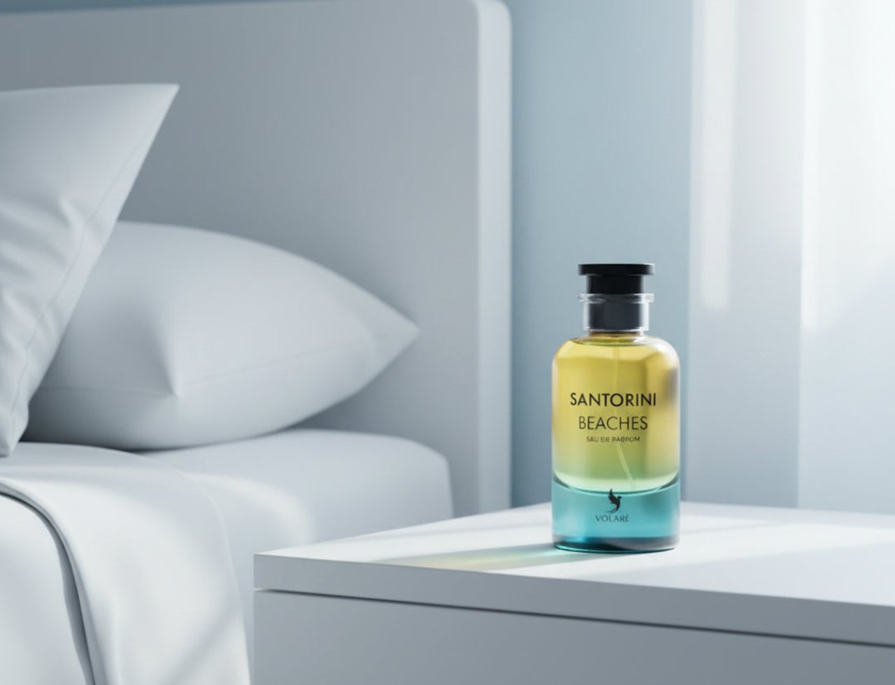 Volare Santorini Beaches by Volare – 100 ml for Her Eau de Parfum bottle with yellow and blue gradient liquid, placed on a white bedside table next to a bed with white pillows.