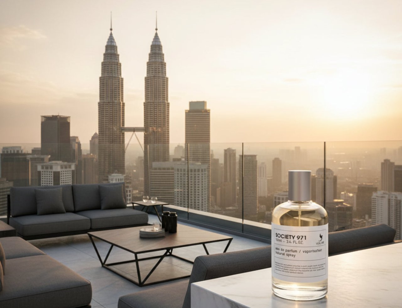 Volare Society 971 by Volare 100ml EDP Men — A clear glass perfume bottle with a silver cap sits on a marble surface, with the Petronas Twin Towers and Kuala Lumpur skyline in the background at sunset.