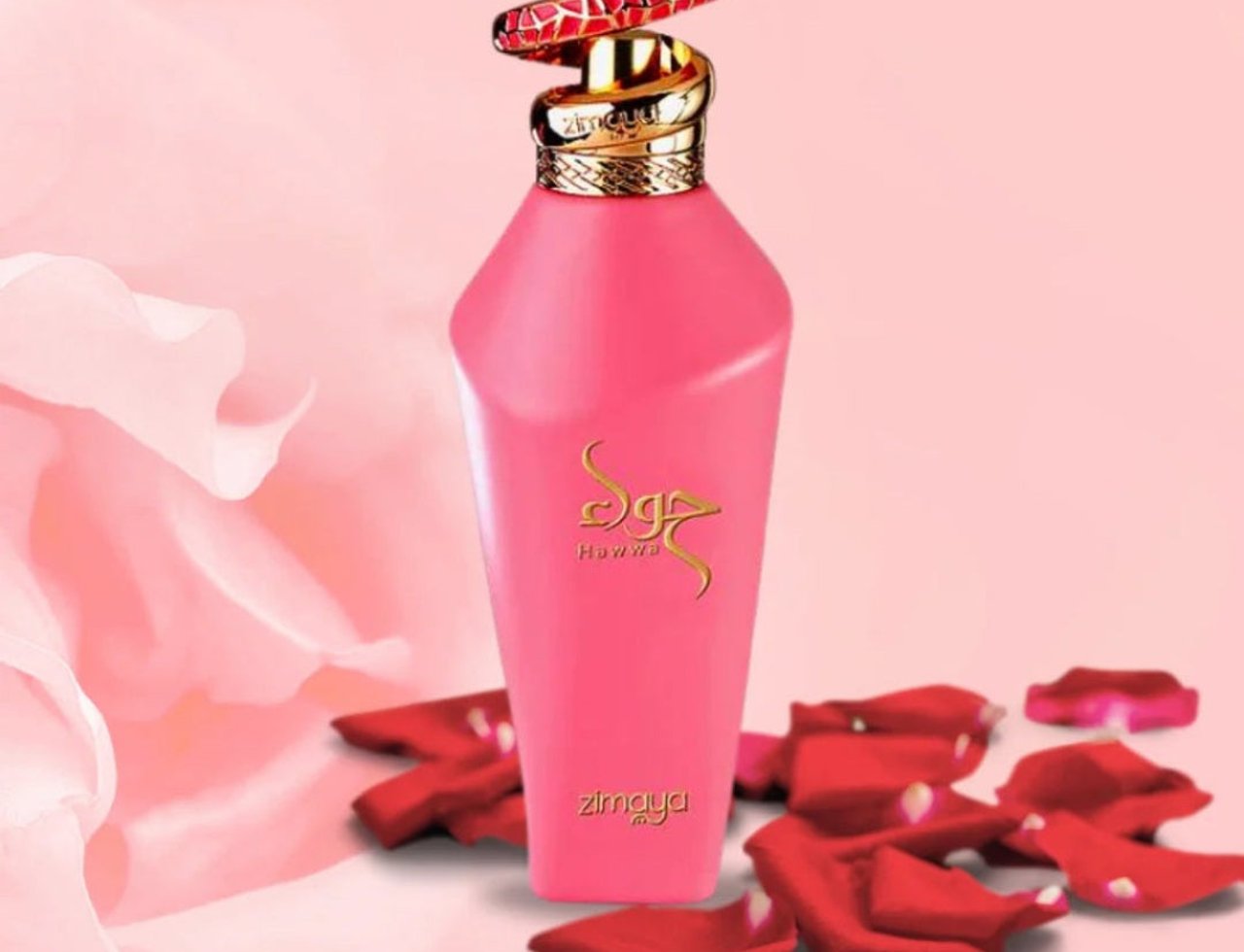 Zimaya Hawwa Pink by Zimaya Women 100ml EDP — Pink perfume bottle with a gold and red patterned cap, surrounded by red rose petals on a pink background with draped fabric.