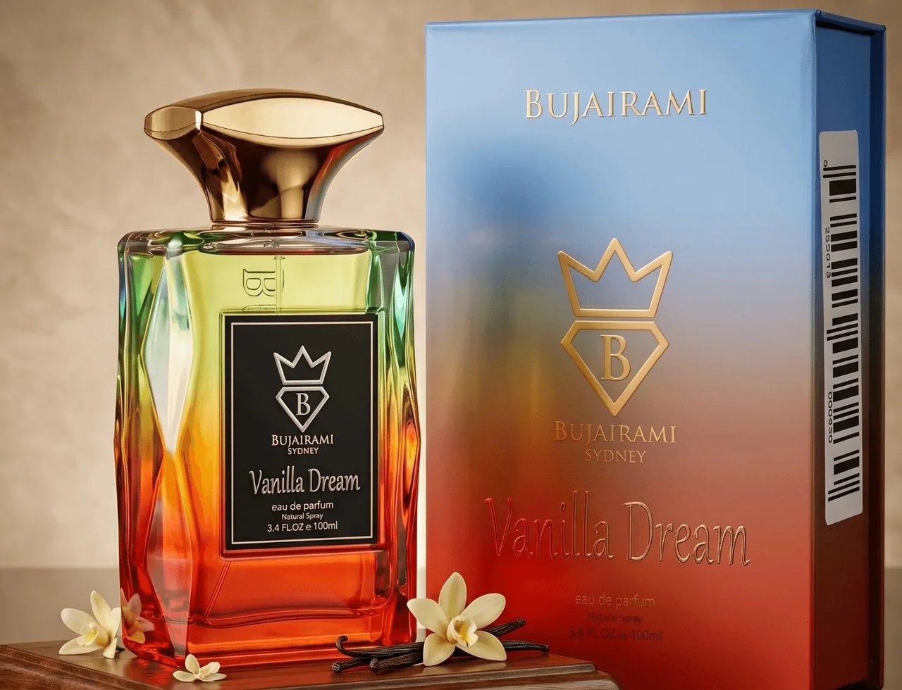Bujairami Vanilla Dream Eau de Parfum — Gradient glass bottle with gold cap, displayed on a wooden stand with vanilla pods and flowers, next to its blue and orange gradient box.
