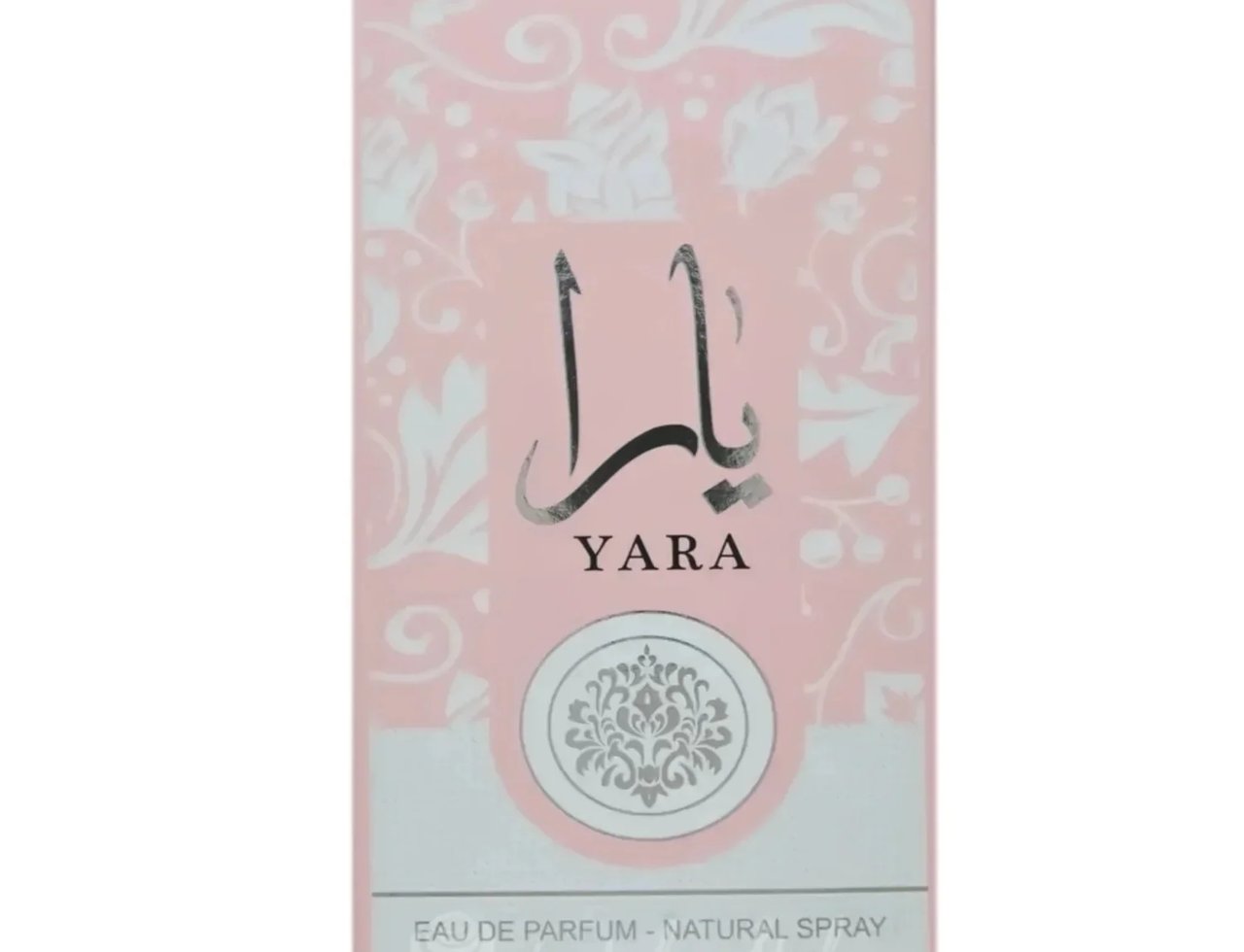 Ard Al Zaafaran Yara Eau De Parfum 50ml by Ard Al Zaafaran — A pink perfume box with white floral patterns and Arabic script above the brand name YARA. | Ard Al Zaafaran Yara Eau De Parfum 50ml by Ard Al Zaafaran — Kotak minyak wangi merah jambu dengan corak bunga putih dan tulisan Arab di atas nama jenama YARA.