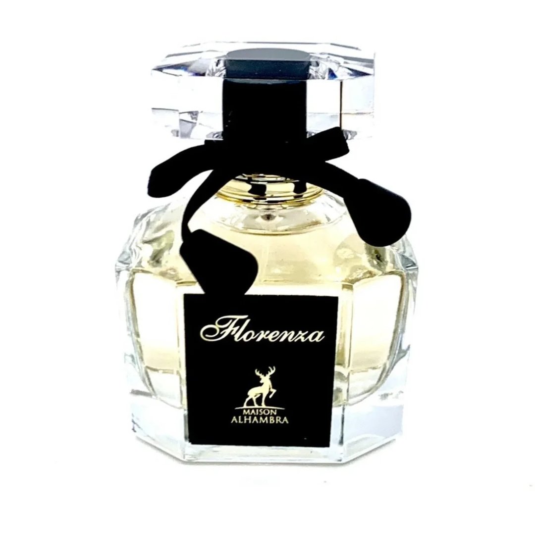 Maison Alhambra Florenza (Florence) 100ml by Maison Alhambra — A clear glass perfume bottle with a black label featuring gold text and a deer silhouette, tied with a black ribbon and topped with a faceted clear cap. | Maison Alhambra Florenza (Florence) 100ml by Maison Alhambra — Botol kaca jernih dengan label hitam