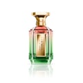 Velixir Harmonia Eau de Parfum — A clear glass perfume bottle with a gradient of pink to green liquid, a gold label with "HARMONIA EAU DE PARFUM" text, and a faceted gold cap, set against a white background with a reflection. | Velixir Harmonia Eau de Parfum — Botol kaca jernih dengan cecair gradien dari merah jambu