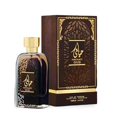 Ard Al Zaafaran Hayaati Oud — A clear glass perfume bottle with dark liquid and a gold cap, next to its brown and gold patterned box, on a white background.